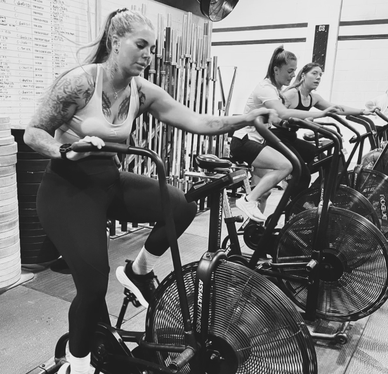 Members using cardio equipment during a cross-training class