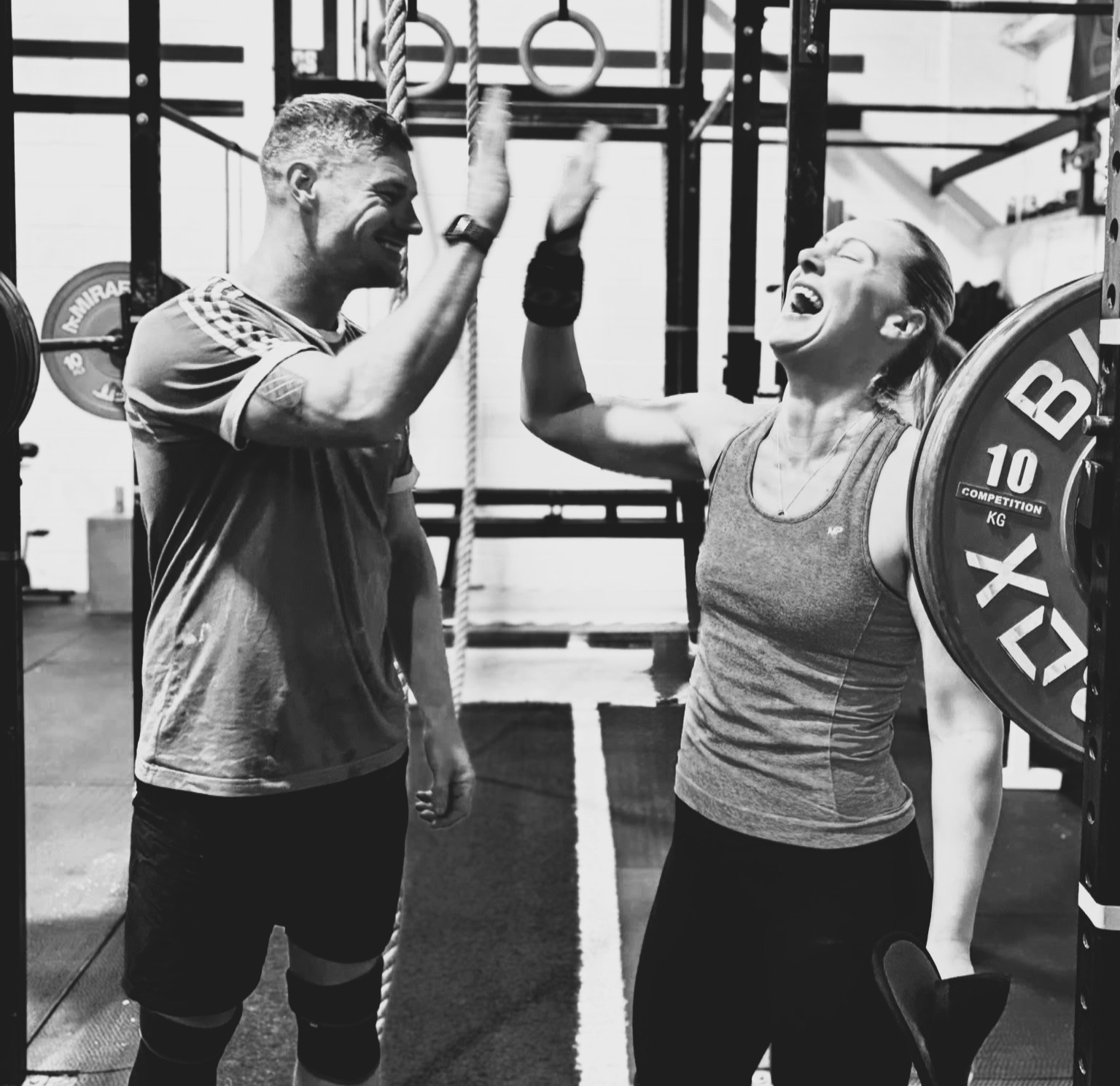 A member successfully lifting a heavy barbell