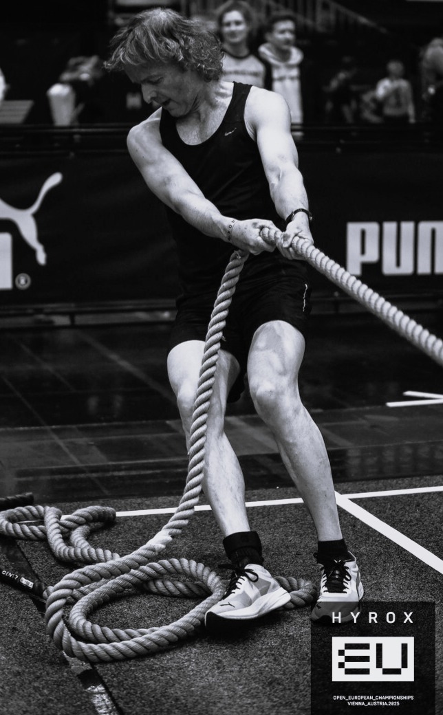 An athlete showing intense focus and mental toughness during a rope exercise